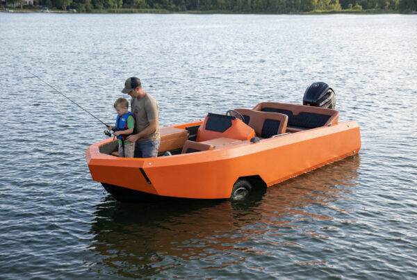 Image of a Dad & son fishing while sitting inside a amphibious boat car